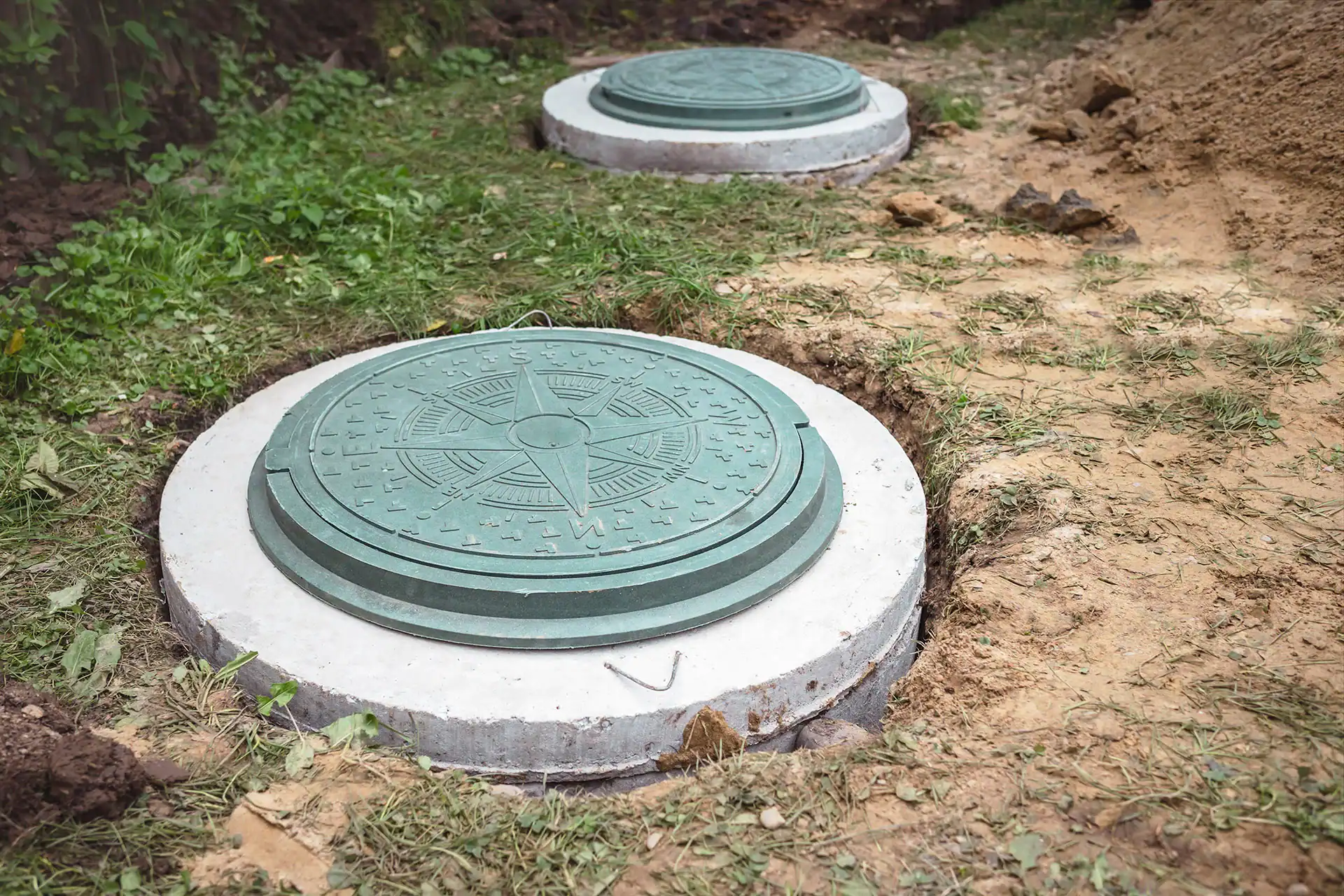 Cesspool cover installed outdoors on a concrete base in a yard.